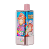 A pink and black handheld vape device with a bright blue label featuring cartoon monkeys in colorful outfits, a pink top cap, and a pink metallic base, with flavor indicators reading Blueberry Ice and Peach Ice.